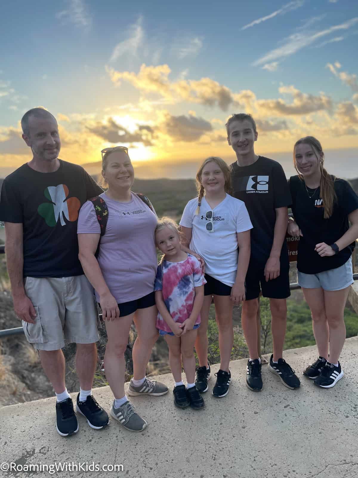 family of 6 with kids standing at the look out spot on Diamond Head trail hike