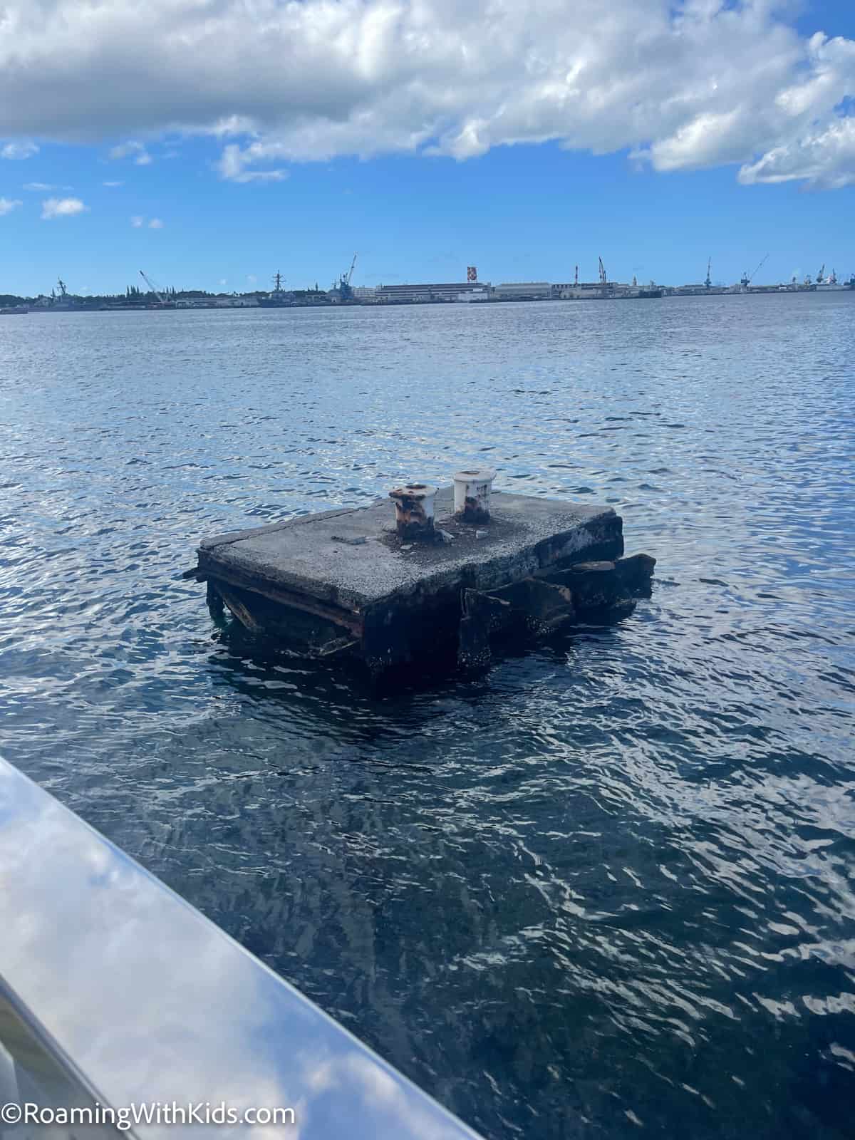 part of the USS Arizona ship sticking out of the water 