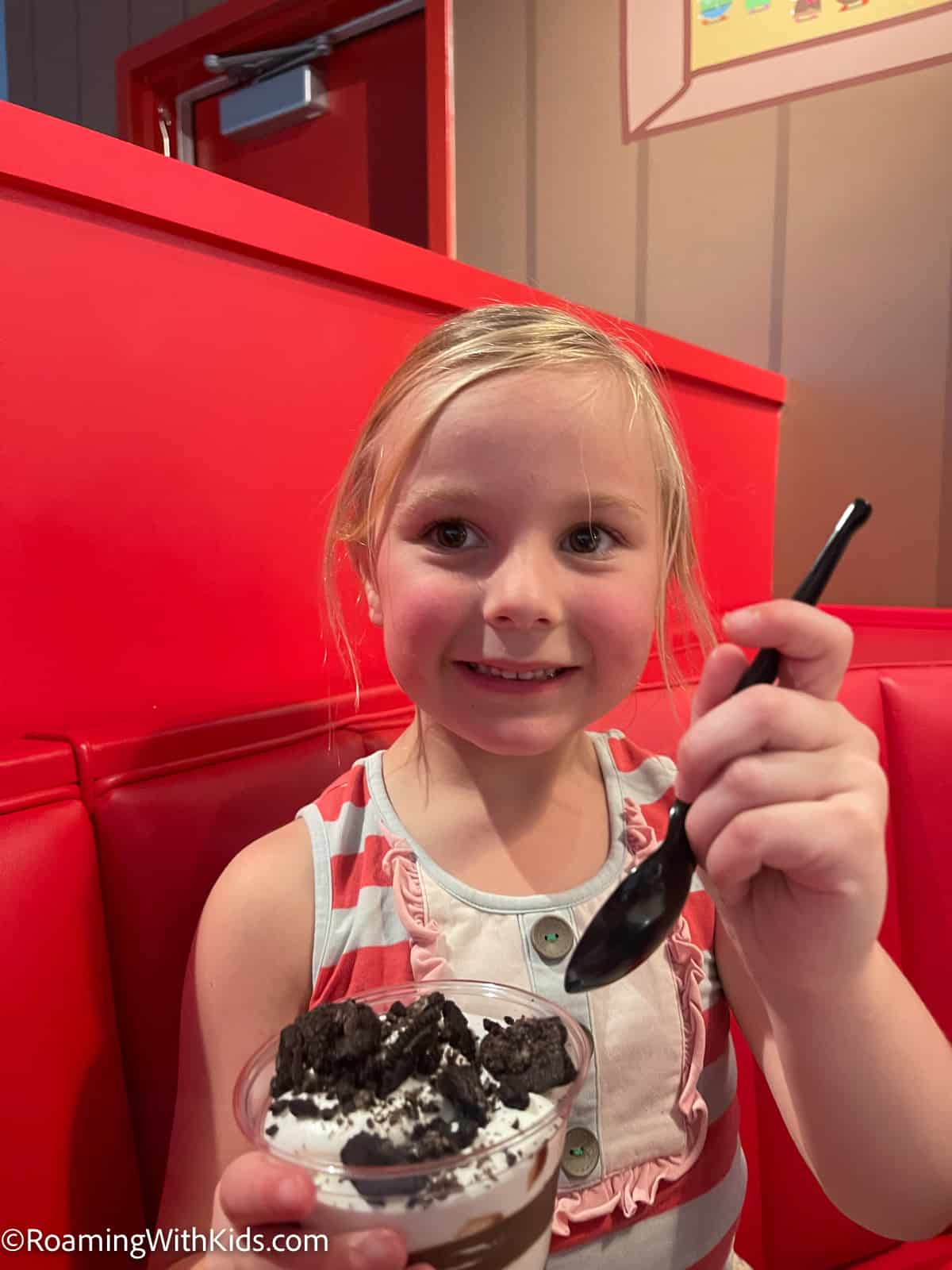 child eating a mud cup at the diner at Peppa Pig theme park in florida