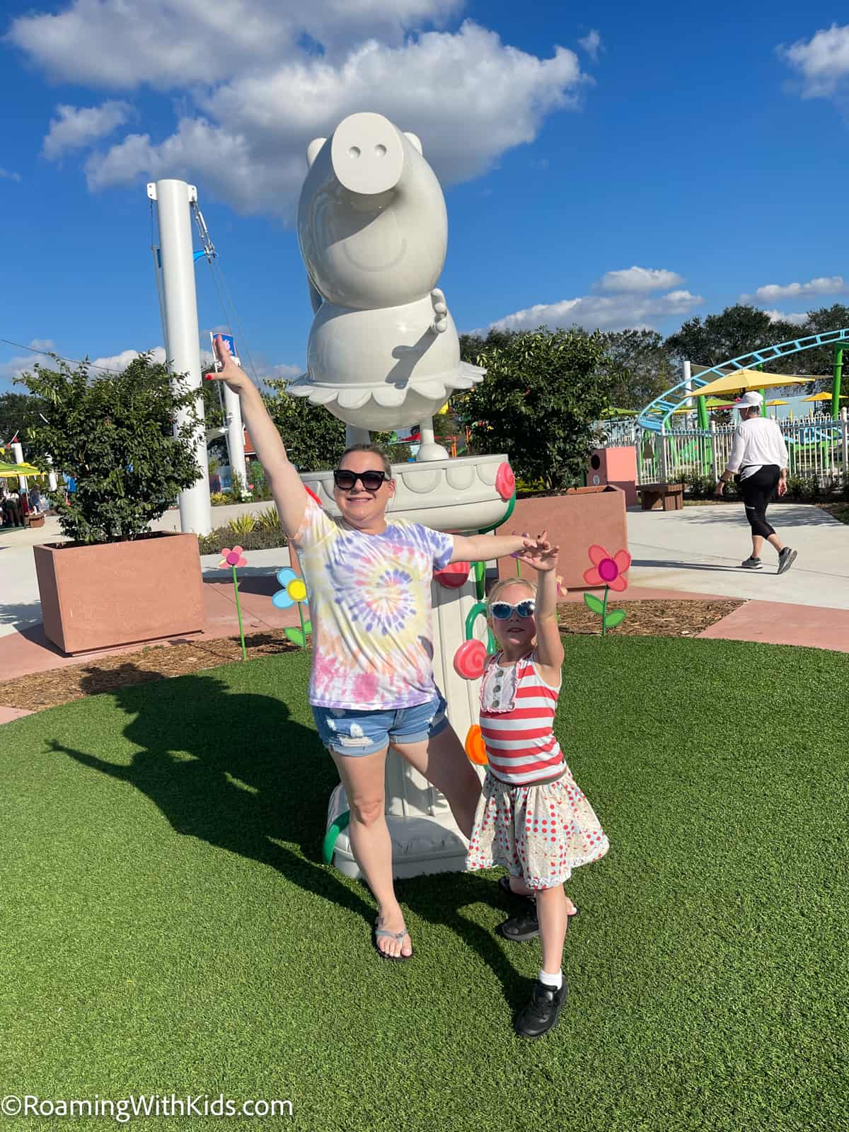 mom and daughter at the Peppa Pig Statue at Peppa Pig theme park in florida