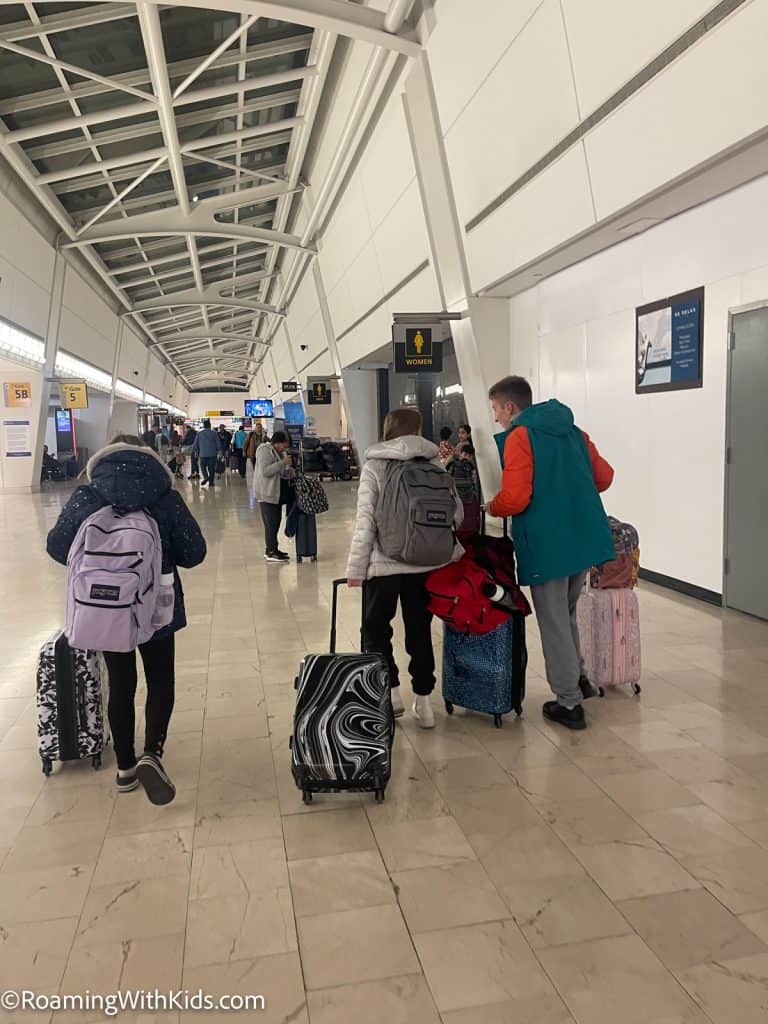 4 kids walking thru an airport