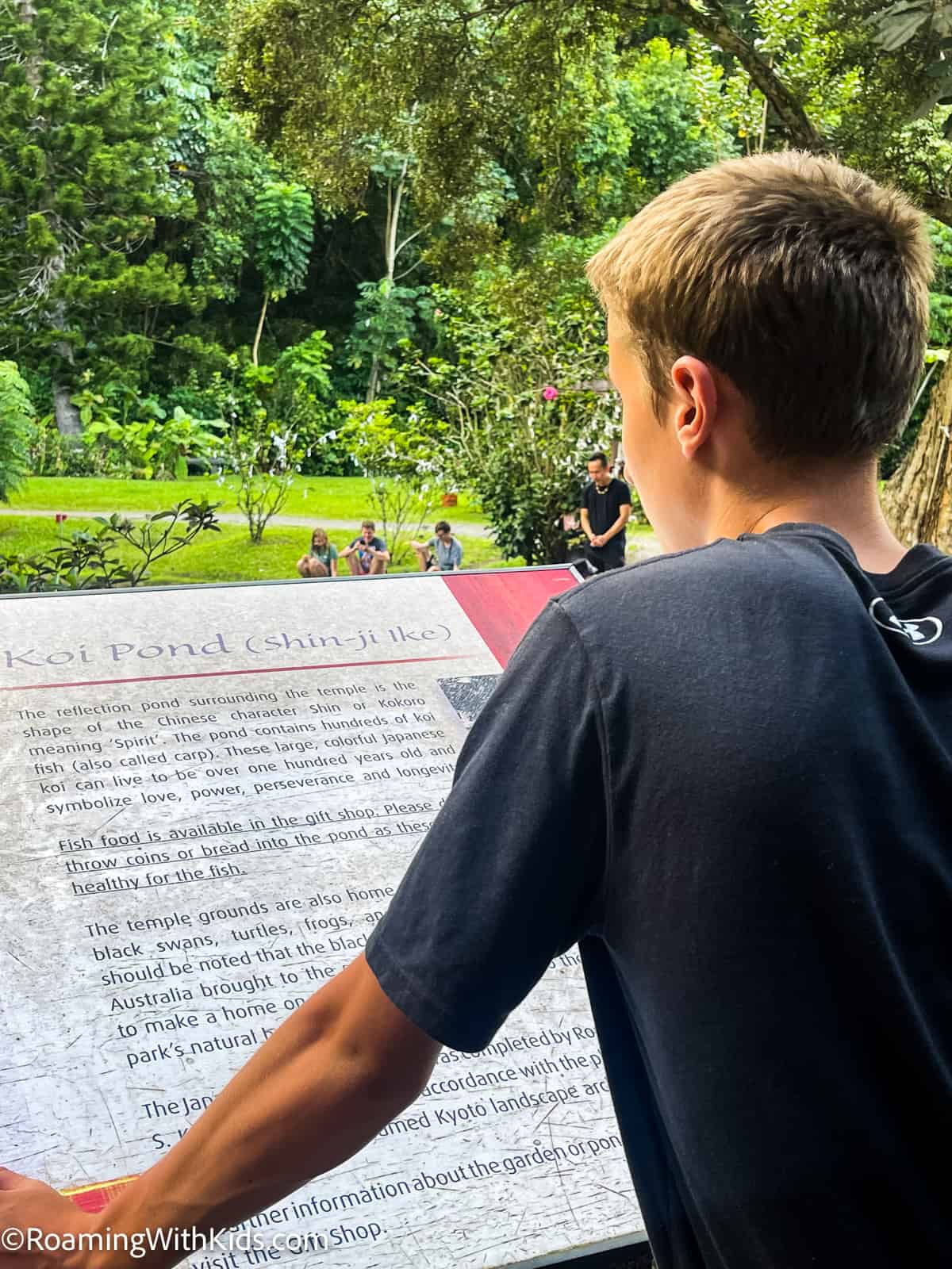 Child reading the informative signs at the Byodo-In Temple